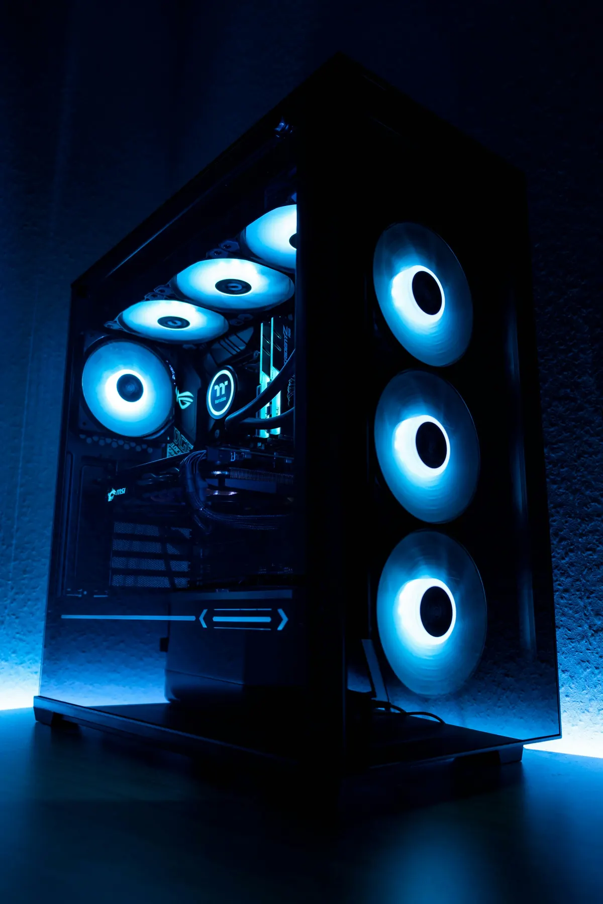 An open computer case on a workbench, with the motherboard and graphics card visible inside